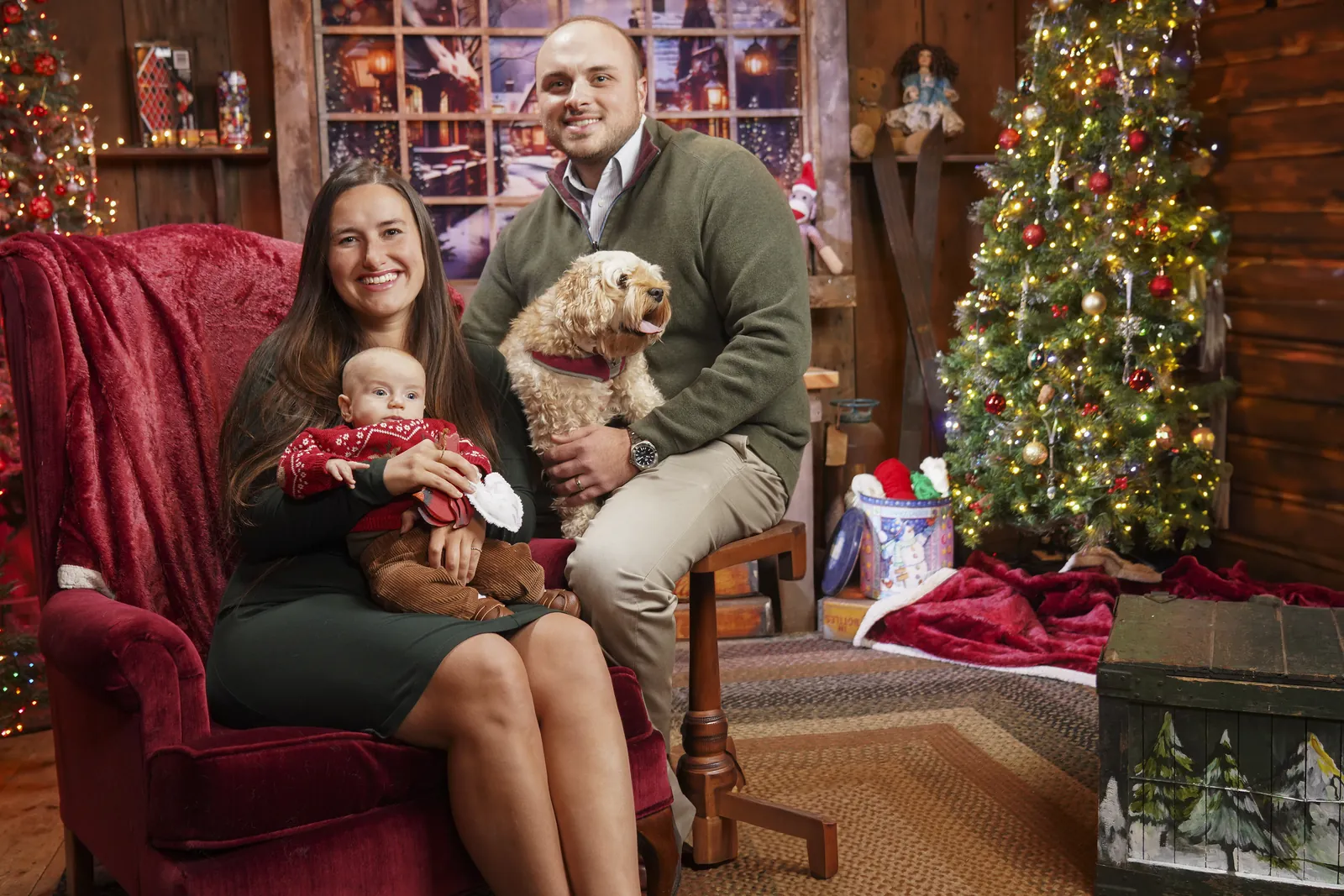 A family with their dog and Santa at the Conklin Barn