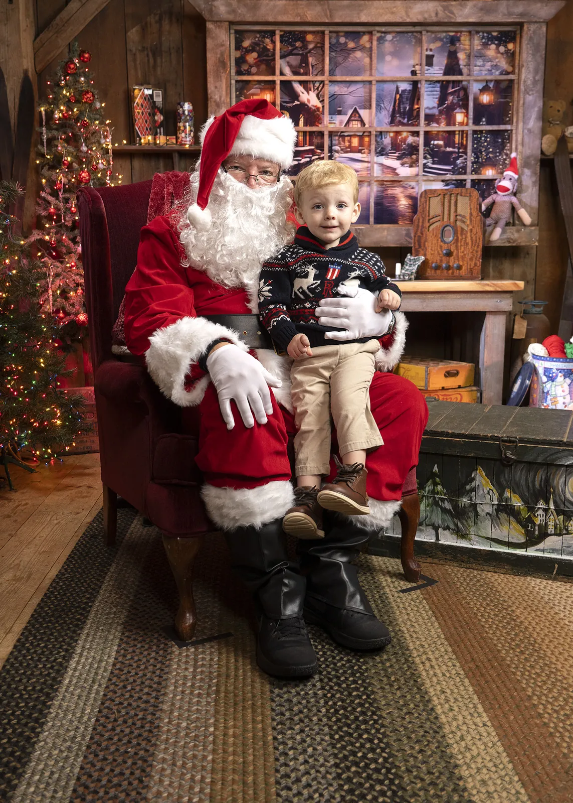 A toddler on Santa's lap at the Conklin Barn