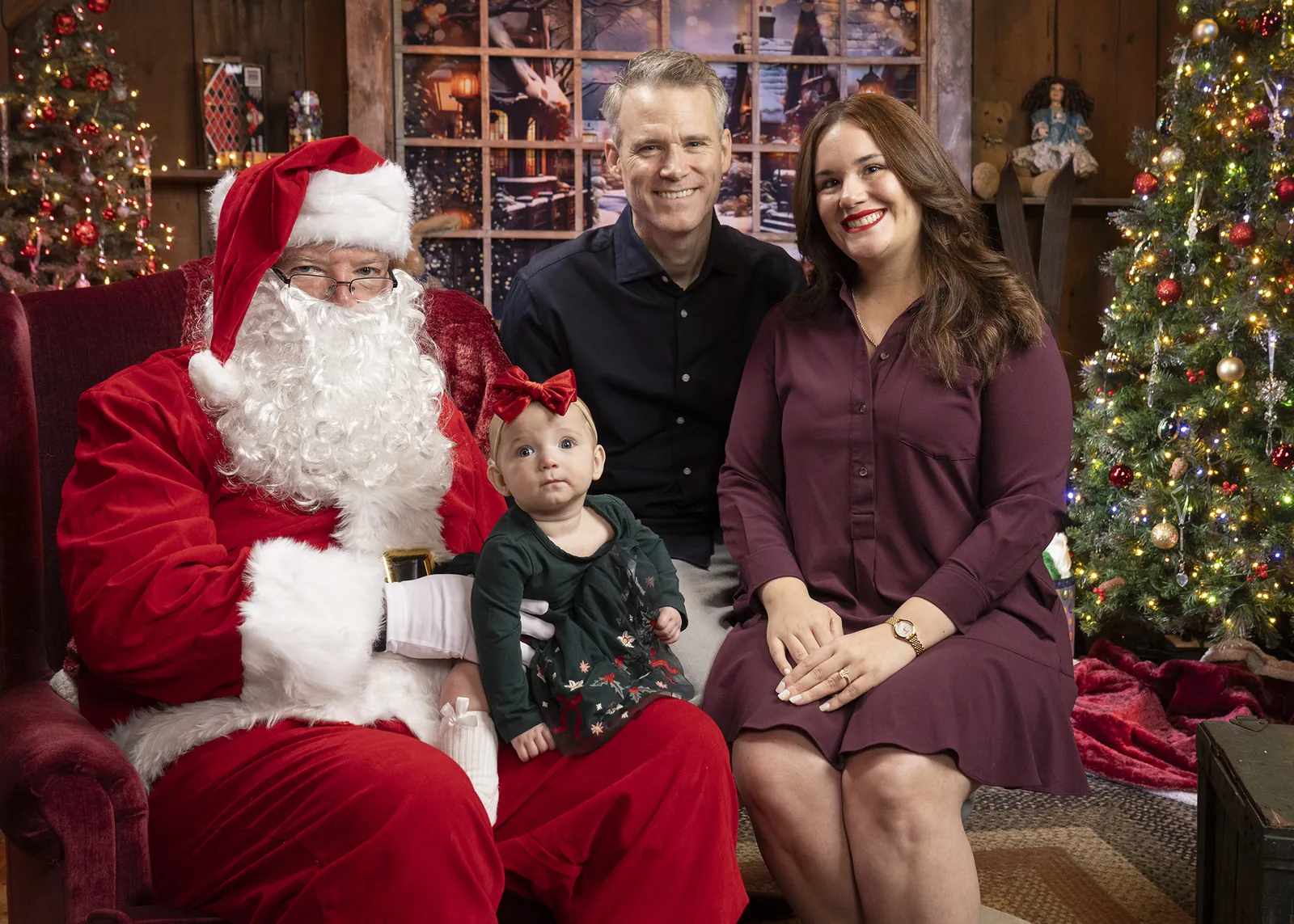 A father and daughter with Santa at the Conklin Barn